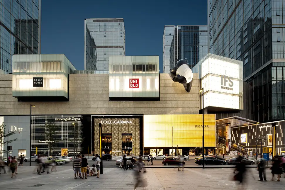 Chengdu IFS at dusk with its climbing panda sculpture, designer storefronts and city traffic