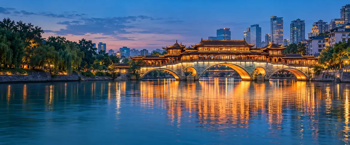 AI-generated Chengdu riverfront scene with a warmly illuminated covered bridge and blue-hour reflections