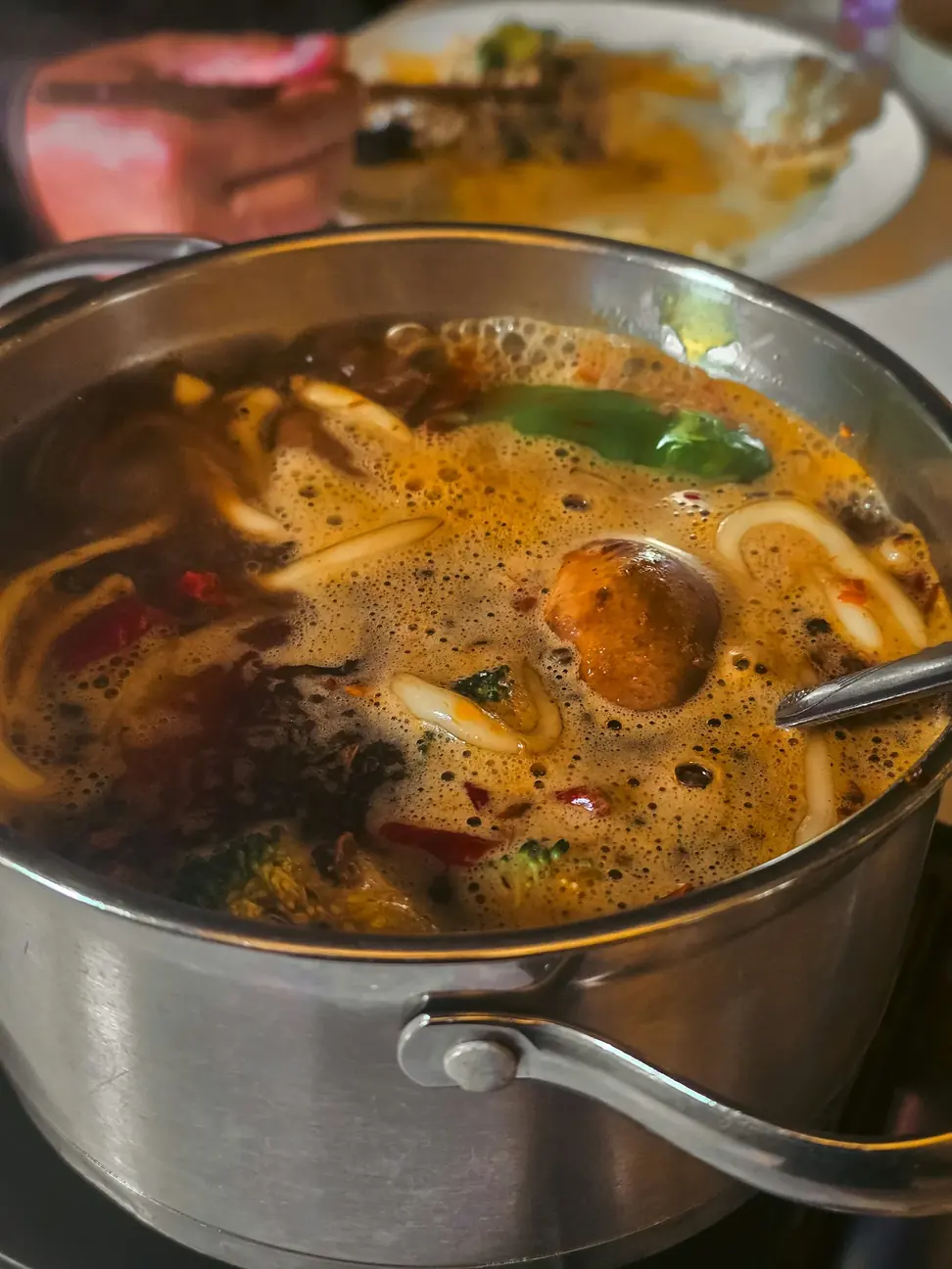 A bowl of noodles in a savory broth at a Chengdu restaurant